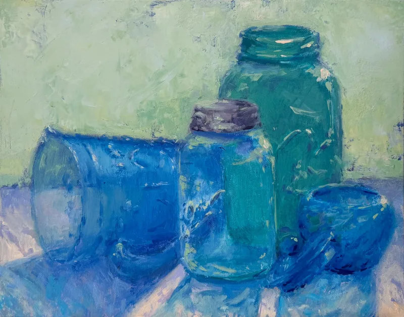 Vintage blue mason jars catching the light.