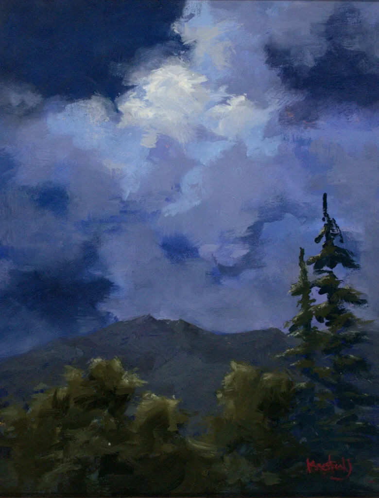 moody landscape with dark storm clouds over a mountain and lone pine tree