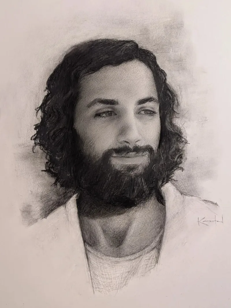 Charcoal portrait of Jesus Christ with long dark hair and beard smiling gently.