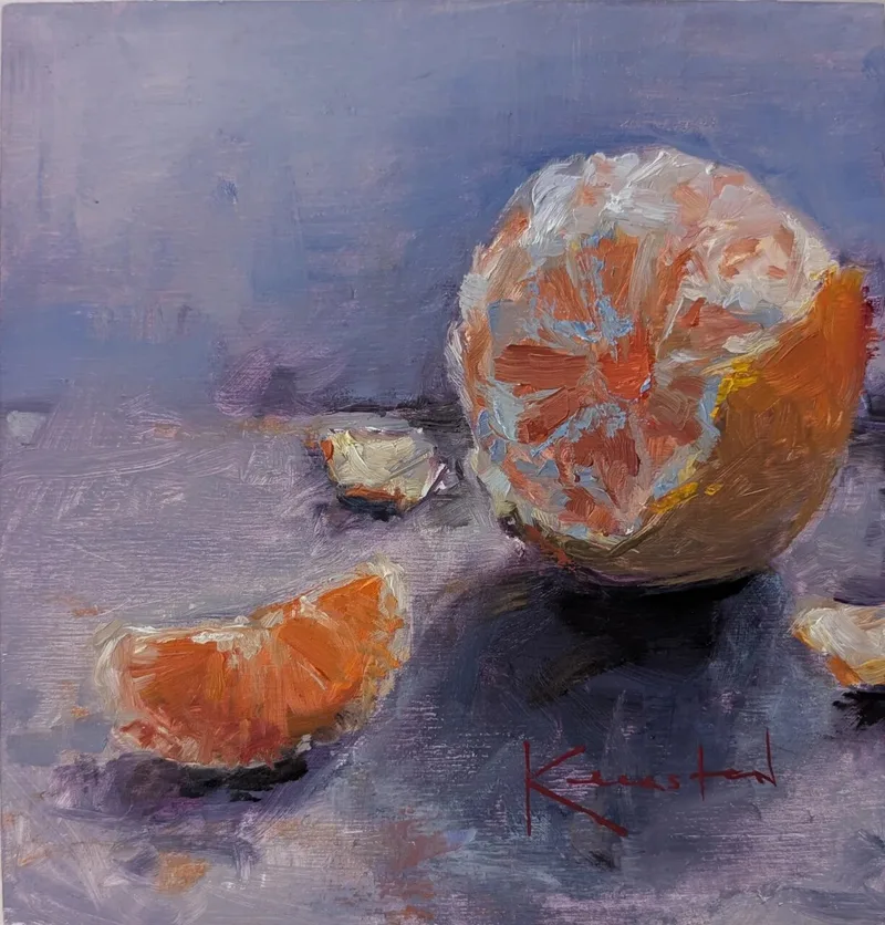 Partially peeled orange with separated wedges on soft purple gray surface