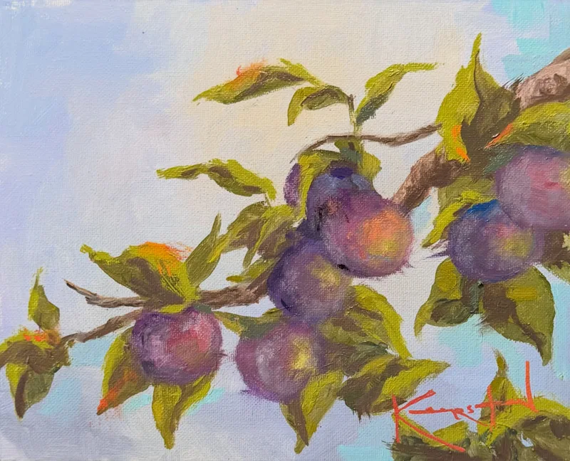 Purple plums ripening on a leafy branch against a soft blue sky.