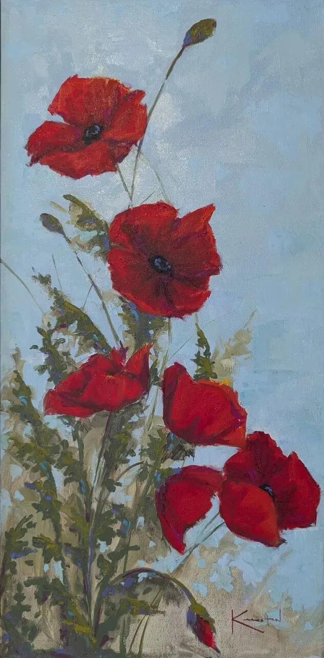 Vivid red poppies on tall stems with foliage against a soft blue sky.