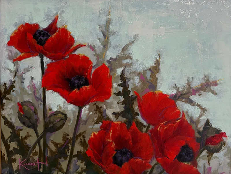 Cluster of open red poppies with nodding buds in a green field.