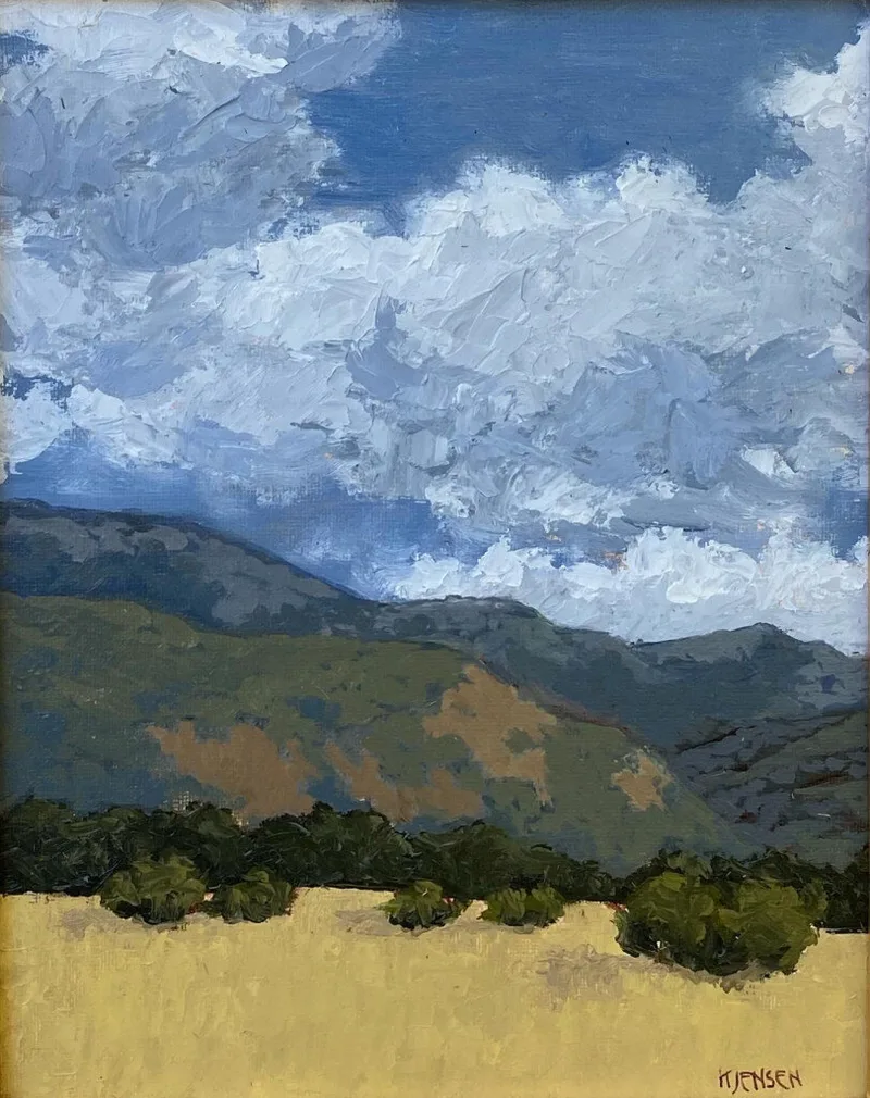 plein air landscape with cloud-filled sky over green hills and foreground bushes