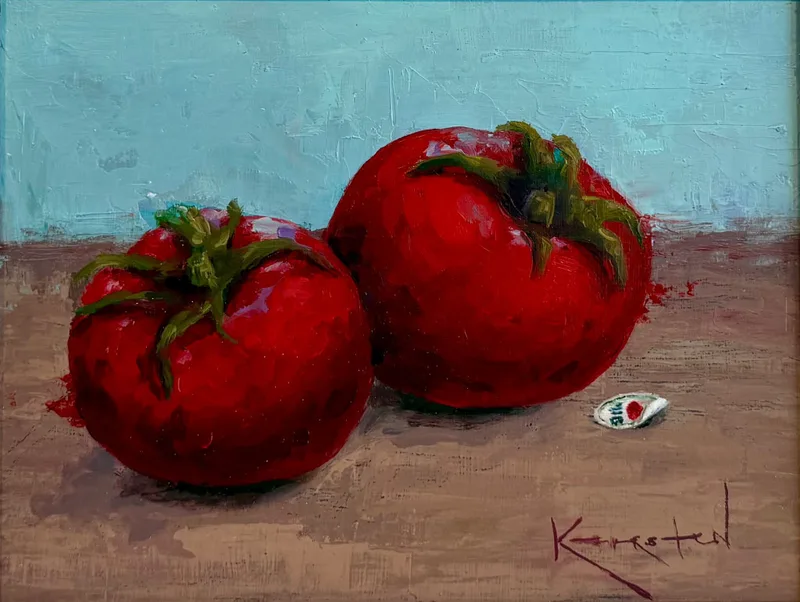 Two plump red tomatoes on a wooden table with a tiny grocery sticker beside them, turquoise background.